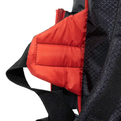 Close-up of a black backpack with red interior pocket on a white background