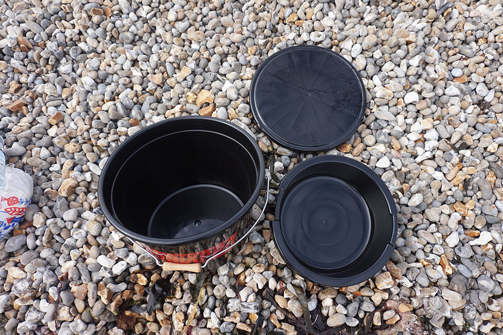 Black plastic pots on a gravel surface