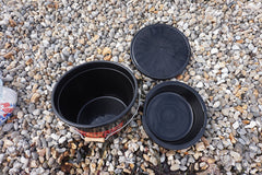 Black plastic pots on a gravel surface